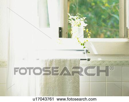 a Bathroom With a White Towel Hanging Near a Window, Front View View Large Photo Image Stock Image - a Bathroom With a White Towel Hanging Near a Window, Front View. Fotosearch