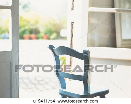 a Blue Wooden Chair Standing Near the Window, Side View, Differential Focus View Large Photo Image Picture - a Blue Wooden Chair Standing Near the Window, Side View, Differential Focus. Fotosearch