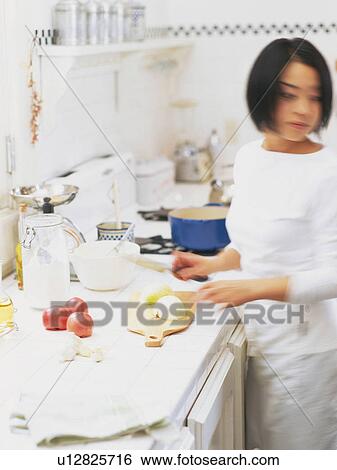 a Mid Adult Woman Cutting Some Vegetables in the Kitchen, Side View, Blurred Motion View Large Photo Image Stock Photograph -  a Mid Adult Woman Cutting Some Vegetables in the Kitchen, Side View, Blurred Motion. Fotosearch