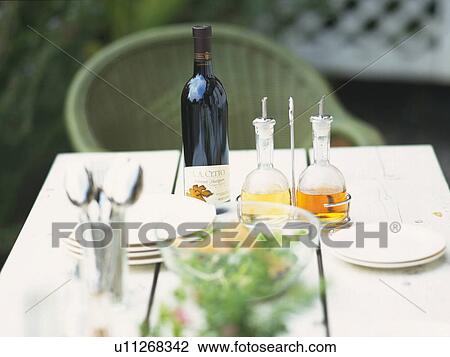 a Setted Table, With a Green Salad, Some Wine and White Porcelain Plates, High Angle View, Differential Focus View Large Photo Image Stock Image - a Setted Table, With a Green Salad, Some Wine and White Porcelain Plates, High Angle View, Differential Focus. Fotosearch
