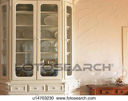 A White Cupboard With Several Dishes Inside Front View Stock