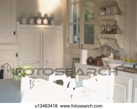 Stock Photo -  a White Kitchen, With the Sunlight Partly Touching the Furniture. Fotosearch