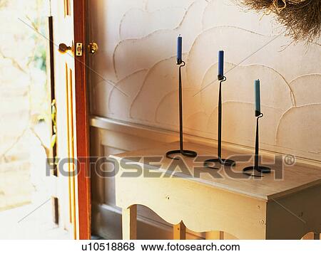 an Entrance With an Open Door, Three Candles Standing on a Wooden Cabinet View Large Photo Image Stock Photo -  an Entrance With an Open Door, Three Candles Standing on a Wooden Cabinet. Fotosearch