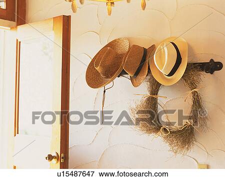 Stock Photo -  an Entrance With Several Hats Hanging By the Wall, Side View. Fotosearch