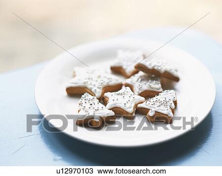 Stock Image - Christmas Cookies on a White Plate, High Angle View. Fotosearch