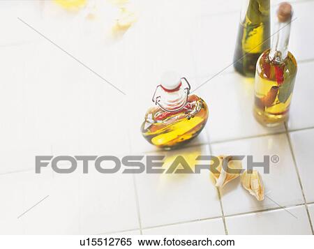 Stock Photography -  Different Kinds of Oil and Several Cloves of Garlic, High Angle View. Fotosearch
