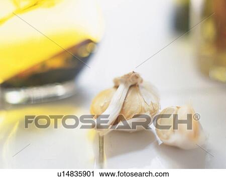 Stock Image -  Several Cloves of Garlic Lying on a White Floor, High Angle View, Differential Focus. Fotosearch