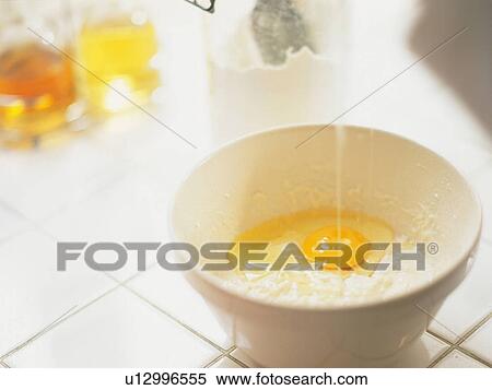 Stock Photography -  Several Ingredients Being Added in a White Porcelain Bowl, High Angle View, Differential Focus. Fotosearch