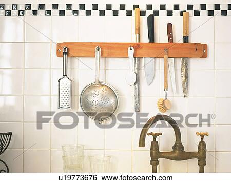 Several Kitchen Items, Such as Knife and Colander Hanging on the Kitchen Wall, Front View View Large Photo Image Stock Photograph - Several Kitchen Items, Such as Knife and Colander Hanging on the Kitchen Wall, Front View. Fotosearch