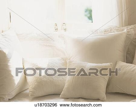 Several White Cushions Near the Window, the Sun Partly Shining on Them, Front View View Large Photo Image Stock Photograph - Several White Cushions Near the Window, the Sun Partly Shining on Them, Front View. Fotosearch