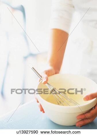 Stock Image -  Someone Holding a White Porcelain Bowl, High Angle View, Differential Focus. Fotosearch