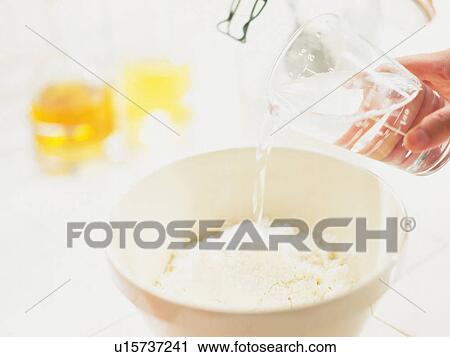 Stock Image -  Someone Putting Several Ingredients Together in the Kitchen, High Angle View, Differential Focus. Fotosearch