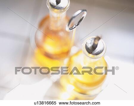 Stock Photography -  Two Bottles Filled With Oil and Vinegar, High Angle View, Differential Focus. Fotosearch