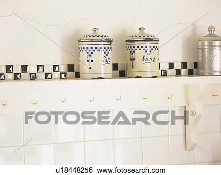 Stock Photograph -  Two Same-colored Pots Standing in the Kitchen In Front of a White Wall, Front View. Fotosearch