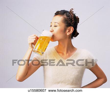 A Woman Drinking a Glass of Beer, Side View View Large Photo Image Stock Photo - A Woman Drinking a Glass of Beer, Side View. Fotosearch