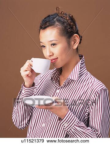 Stock Photo - A Woman Drinking Coffee, Side View. Fotosearch