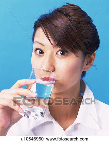 A Woman Drinking Water, Looking at Camera, Front View View Large Photo Image Stock Image - A Woman Drinking Water, Looking at Camera, Front View . Fotosearch