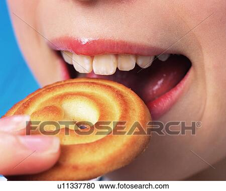 A Woman Eating a Cookie, Close Up View Large Photo Image Stock Image - A Woman Eating a Cookie, Close Up. Fotosearch