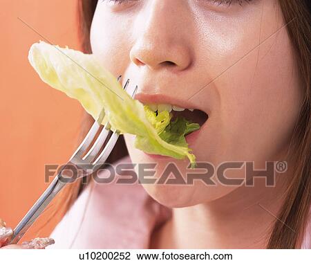 A Woman Eating a Salad, Side View, Close Up View Large Photo Image Stock Image - A Woman Eating a Salad, Side View, Close Up. Fotosearch