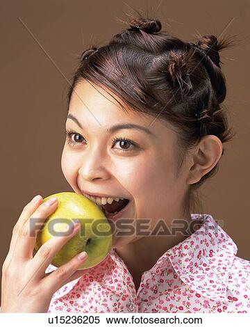 A Woman Eating Green Apple, Side View View Large Photo Image Stock Photography - A Woman Eating Green Apple, Side View . Fotosearch