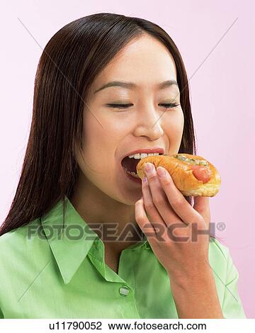 A Woman Eating Hot Dog, Side View  View Large Photo Image Stock Image - A Woman Eating Hot Dog, Side View . Fotosearch