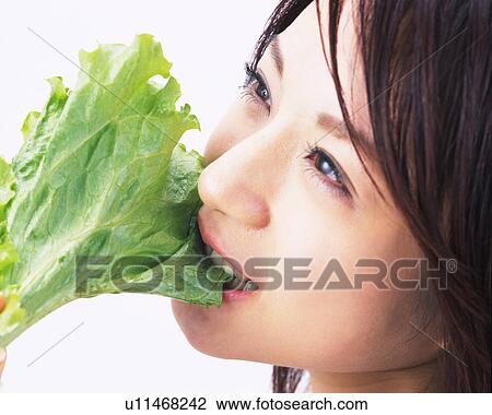 A Woman Eating Lettuce, Side View, Close Up View Large Photo Image Stock Image - A Woman Eating Lettuce, Side View, Close Up. Fotosearch