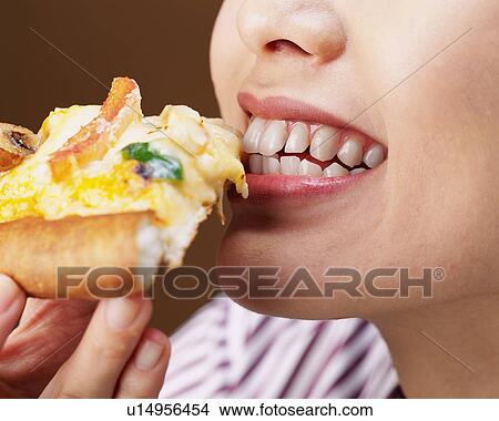 A Woman Eating Pizza, Close Up, Low Angle View View Large Photo Image Picture - A Woman Eating Pizza, Close Up, Low Angle View. Fotosearch
