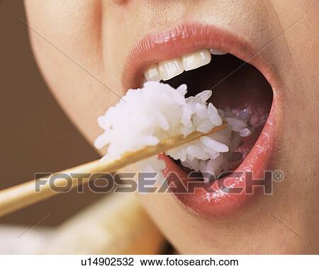 A Woman Eating Rice, Close Up, Close Up View Large Photo Image Stock Image - A Woman Eating Rice, Close Up, Close Up. Fotosearch