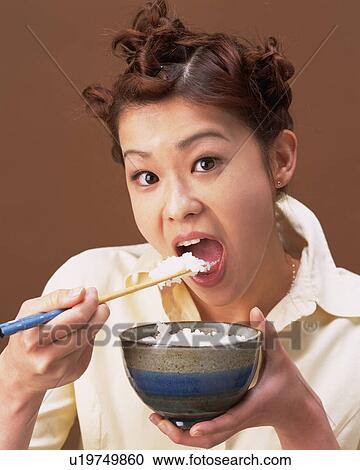 A Woman Eating Rice, Looking at Camera, Front View View Large Photo Image Stock Image - A Woman Eating Rice, Looking at Camera, Front View. Fotosearch