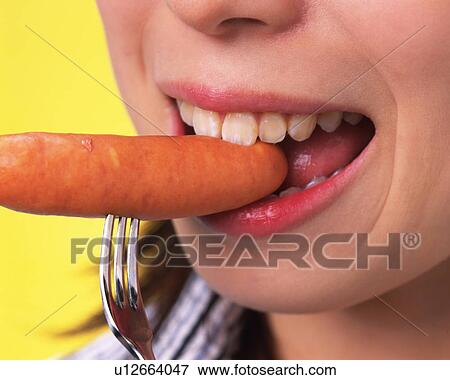 A Woman Eating Sausage, Close Up, Side View View Large Photo Image Stock Photo - A Woman Eating Sausage, Close Up, Side View. Fotosearch