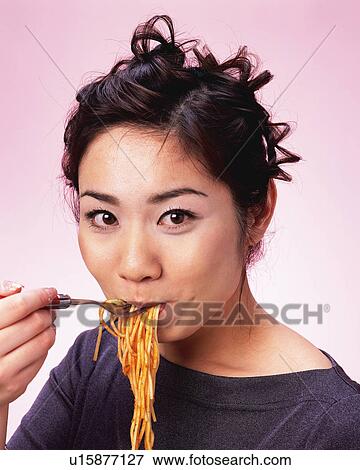 A Woman Eating Spaghetti, Looking at Camera, Front View View Large Photo Image Stock Photo - A Woman Eating Spaghetti, Looking at Camera, Front View . Fotosearch