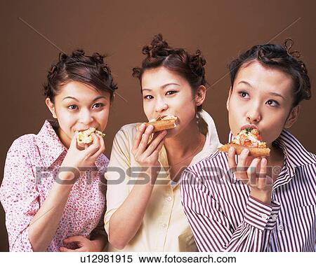 Stock Photography - Three Young Women Eating Pizza, Front View, Looking at Camera. Fotosearch