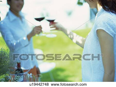 Stock Photo - Two Young Women with Wineglasses. Fotosearch