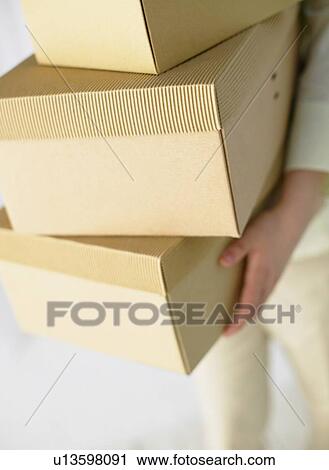 Stock Image - Holding Boxes. Fotosearch
