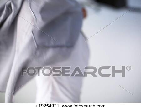 Man who put on a shirt View Large Photo Image Stock Image - Man who put on a shirt. Fotosearch
