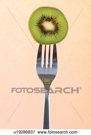 Stock Photo - close-up, cut, fork, fresh fruit. Fotosearch