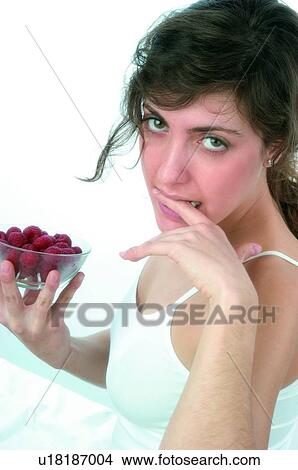 Picture - Woman, Brown hair, Beauty, White undershit, White, Red Currant Berry, Opening mouth. Fotosearch