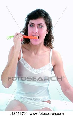 Woman, Brown hair, Beauty, White undershit, White, Carrot, Biting View Large Photo Image Picture - Woman, Brown hair, Beauty, White undershit, White, Carrot, Biting. Fotosearch