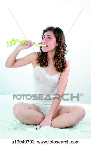 Stock Image - Woman, Brown hair, Beauty, White undershit, White, Socks, Crossed legs. Fotosearch