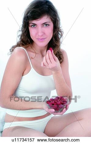 Woman, Brown hair, Beauty, White undershit, White, Red Currant Berry, Opening mouth View Large Photo Image Stock Photo - Woman, Brown hair, Beauty, White undershit, White, Red Currant Berry, Opening mouth. Fotosearch