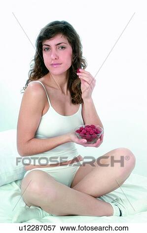 Woman, Brown hair, Beauty, White undershit, White, Red Currant Berry, Opening mouth View Large Photo Image Stock Photo - Woman, Brown hair, Beauty, White undershit, White, Red Currant Berry, Opening mouth. Fotosearch