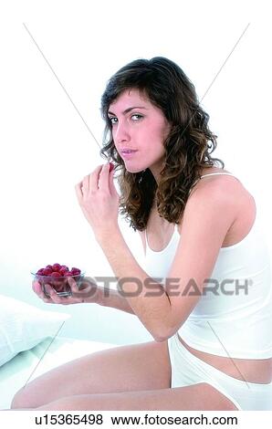 Woman, Brown hair, Beauty, White undershit, White, Red Currant Berry, Opening mouth View Large Photo Image Stock Photo - Woman, Brown hair, Beauty, White undershit, White, Red Currant Berry, Opening mouth. Fotosearch
