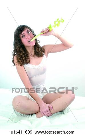 Stock Photo - Woman, Brown hair, Beauty, White undershit, White, Socks, Crossed legs. Fotosearch