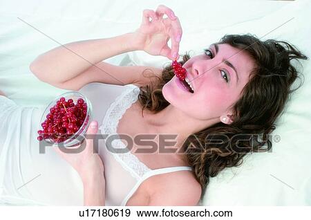 Woman, Brown hair, Beauty, White undershit, White, Red Currant Berry, Opening mouth View Large Photo Image Stock Photo - Woman, Brown hair, Beauty, White undershit, White, Red Currant Berry, Opening mouth. Fotosearch