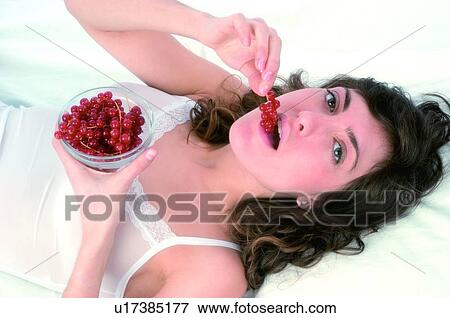 Woman, Brown hair, Beauty, White undershit, White, Red Currant Berry, Opening mouth View Large Photo Image Stock Photo - Woman, Brown hair, Beauty, White undershit, White, Red Currant Berry, Opening mouth. Fotosearch