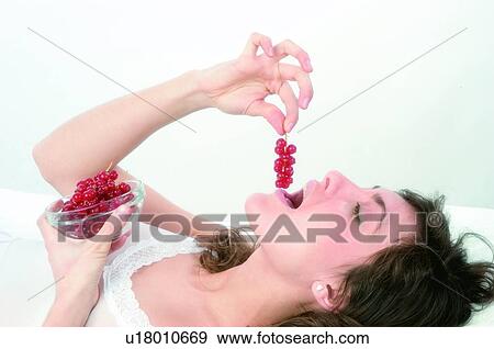 Woman, Brown hair, Beauty, White undershit, White, Red Currant Berry, Opening mouth View Large Photo Image Stock Photo - Woman, Brown hair, Beauty, White undershit, White, Red Currant Berry, Opening mouth. Fotosearch