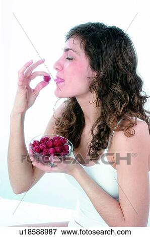Woman, Brown hair, Beauty, White undershit, White, Red Currant Berry, Opening mouth View Large Photo Image Stock Photo - Woman, Brown hair, Beauty, White undershit, White, Red Currant Berry, Opening mouth. Fotosearch