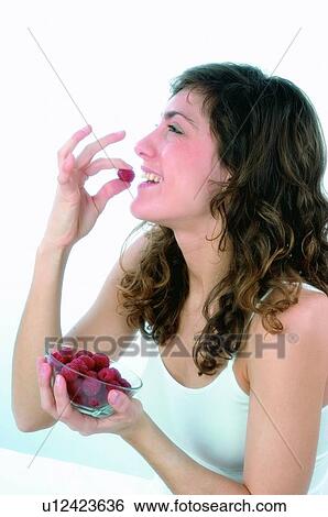 Woman, Brown hair, Beauty, White undershit, White, Red Currant Berry, Opening mouth View Large Photo Image Stock Photograph - Woman, Brown hair, Beauty, White undershit, White, Red Currant Berry, Opening mouth. Fotosearch