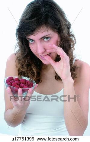 Woman, Brown hair, Beauty, White undershit, White, Red Currant Berry, Opening moth View Large Photo Image Stock Photograph - Woman, Brown hair, Beauty, White undershit, White, Red Currant Berry, Opening moth. Fotosearch