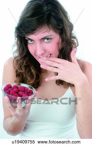 Woman, Brown hair, Beauty, White undershit, White, Red Currant Berry, Opening mouth View Large Photo Image Stock Photography - Woman, Brown hair, Beauty, White undershit, White, Red Currant Berry, Opening mouth. Fotosearch